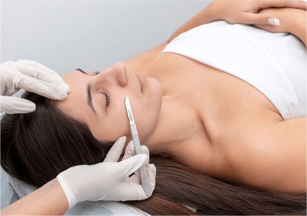 Closeup of the doctor with a scalpel treating the woman's.